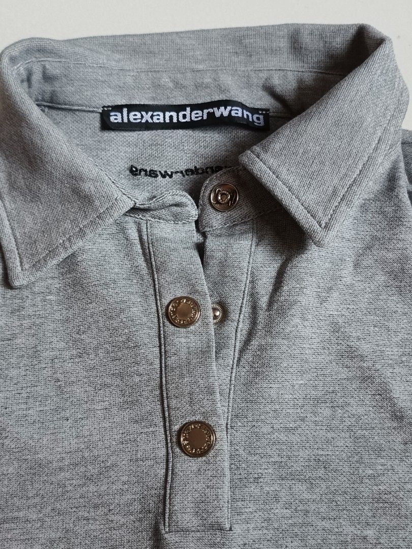 Alexander Wang Cropped Polo Shirt (Category: Tshirts & Polo Shirts ) located in Cabuyao City. Submitted by burberrymaki (Listing ID 1438176460, Image 3). Description: - Alexander Wang cropped polo shirt - Color: Gray - Size: M (fit to s-m) - Features a collared neckline - Short sleeves - Button closure - 100% cotton.