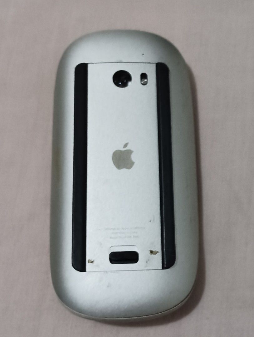Apple Magic Mouse (Category: Mouse & Mousepads) located in Caloocan City. Submitted by bg_geniusph (Listing ID 1438231351, Image 1). Description: - Apple Magic Mouse - Silver finish - Requires 2 AA batteries (not included) - Includes battery compartment cover - Apple logo visible.