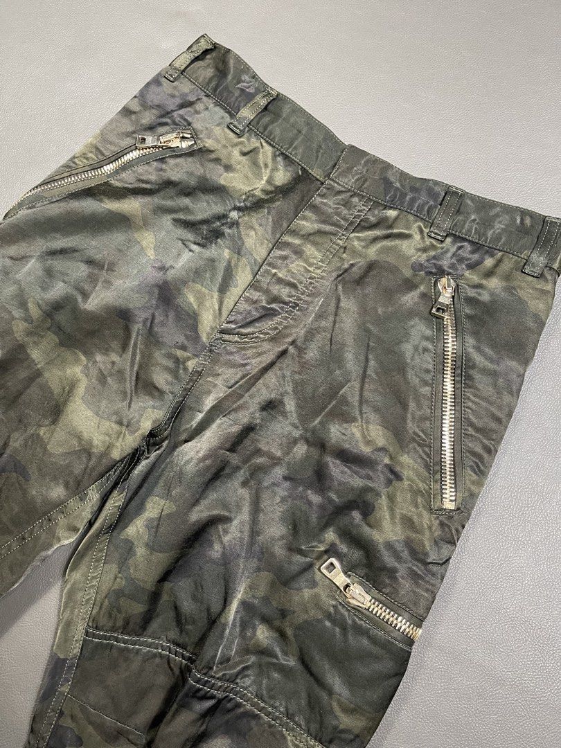 Balmain FW17 camouflage cargo pants (Category: Jeans) located in Caloocan City. Submitted by dapreluv (Listing ID 1438238261, Image 3). Description: Balmain FW17 camouflage cargo pants release under Olivier Rousteing’s creative direction. with zip detailing Heavy silvertone statement zippers on the front hip, side cargo areas, rear pockets, and prominent zippers at the inner/outer ankle cuffs. The 42% Rayon blend gives the camouflage pattern a di