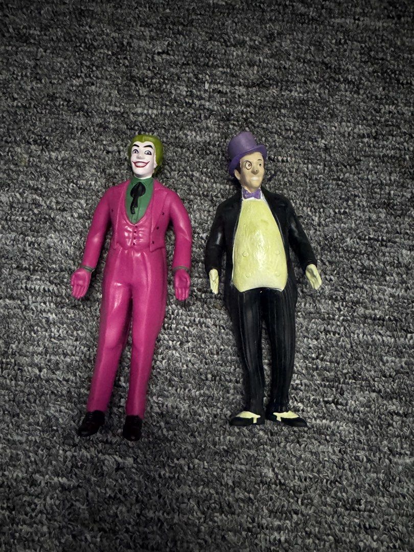 Batman The Joker and Penguin Action Figures Vintage (Category: Toys & Games) located in President Roxas. Submitted by isserminator (Listing ID 1438303006, Image 1). Description: - Vintage Batman action figures featuring The Joker and The Penguin. - The Joker: Pink suit, green hair. - The Penguin: Black suit, purple hat. - Figures marked with "njcroce.com" and "TM & DC Comics." - Made in China..