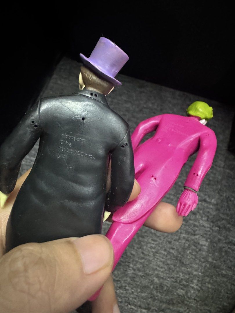 Batman The Joker and Penguin Action Figures Vintage (Category: Toys & Games) located in President Roxas. Submitted by isserminator (Listing ID 1438303006, Image 3). Description: - Vintage Batman action figures featuring The Joker and The Penguin. - The Joker: Pink suit, green hair. - The Penguin: Black suit, purple hat. - Figures marked with "njcroce.com" and "TM & DC Comics." - Made in China..