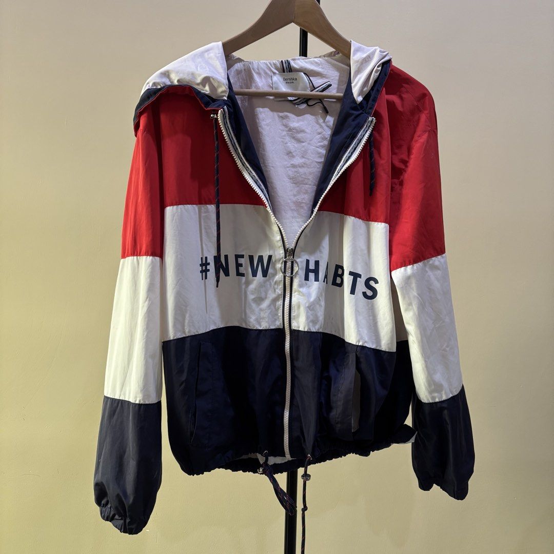 Bershka Colorblock Jacket (Category: Coats, Jackets and Outerwear) located in Quezon City. Submitted by declutternami (Listing ID 1438205998, Image 1). Description: - Bershka colorblock jacket - Size: L - Features: - Hood - Zip-up front - Drawstring hem - '#NEW HABITS' print - Colors: Red, white, and navy - Made in Morocco Large size As is rfs: Declutter Pickup only: QC loc.