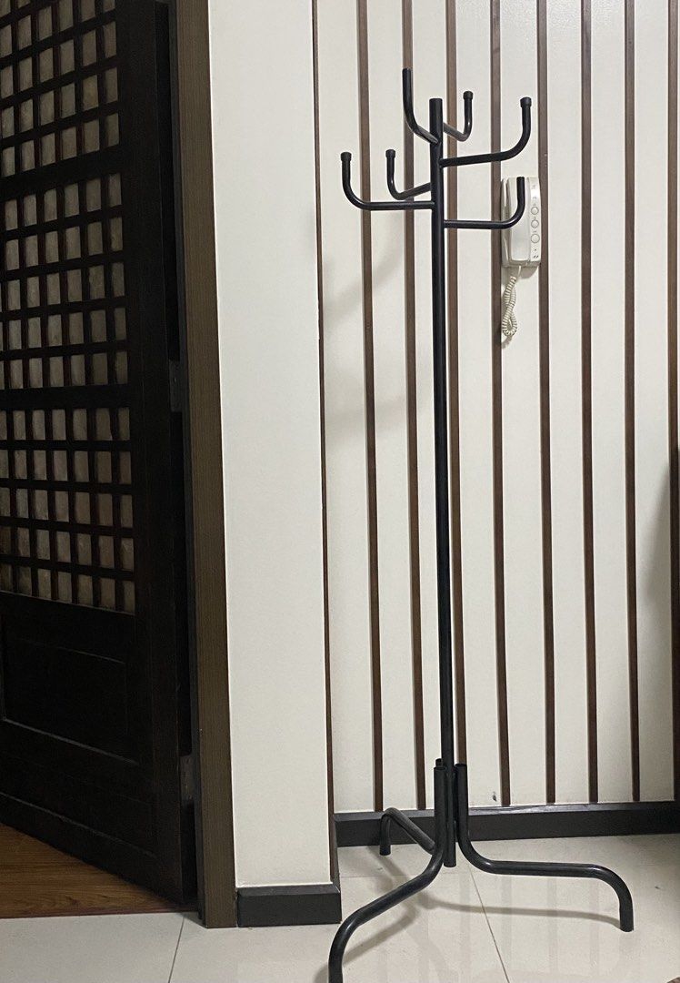 Black Metal Coat Rack (Category: Shelves, Cabinets & Racks) located in Quezon City. Submitted by waytodeclutter (Listing ID 1438258297, Image 1). Description: - Black metal coat rack - Multiple hooks for coats, hats, and bags - Different hook heights - Sturdy base for stability - Sleek design - Space-saving solution.