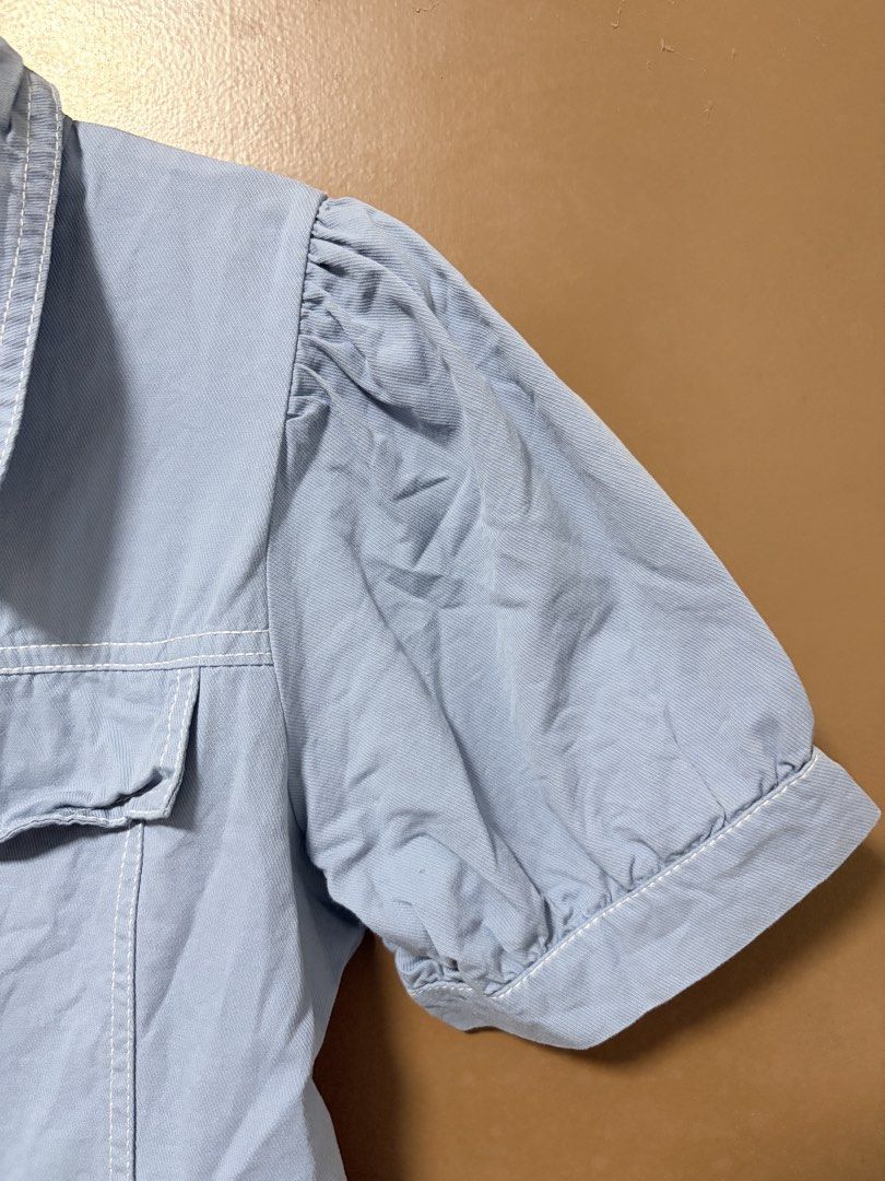 Blue/Denim-like Button-Down Puff Sleeved Dress (Category: Dresses) located in Meycauayan. Submitted by _cbear (Listing ID 1438271659, Image 3). Description: - Light blue/Light Denim Colored dress - White stitching details - Collared neckline - Short puff sleeves - Button-down front - Two chest pockets - Slightly flared skirt - Lightweight HQ Fabric - XS to M - an inch or so above the knee of a 5’3.