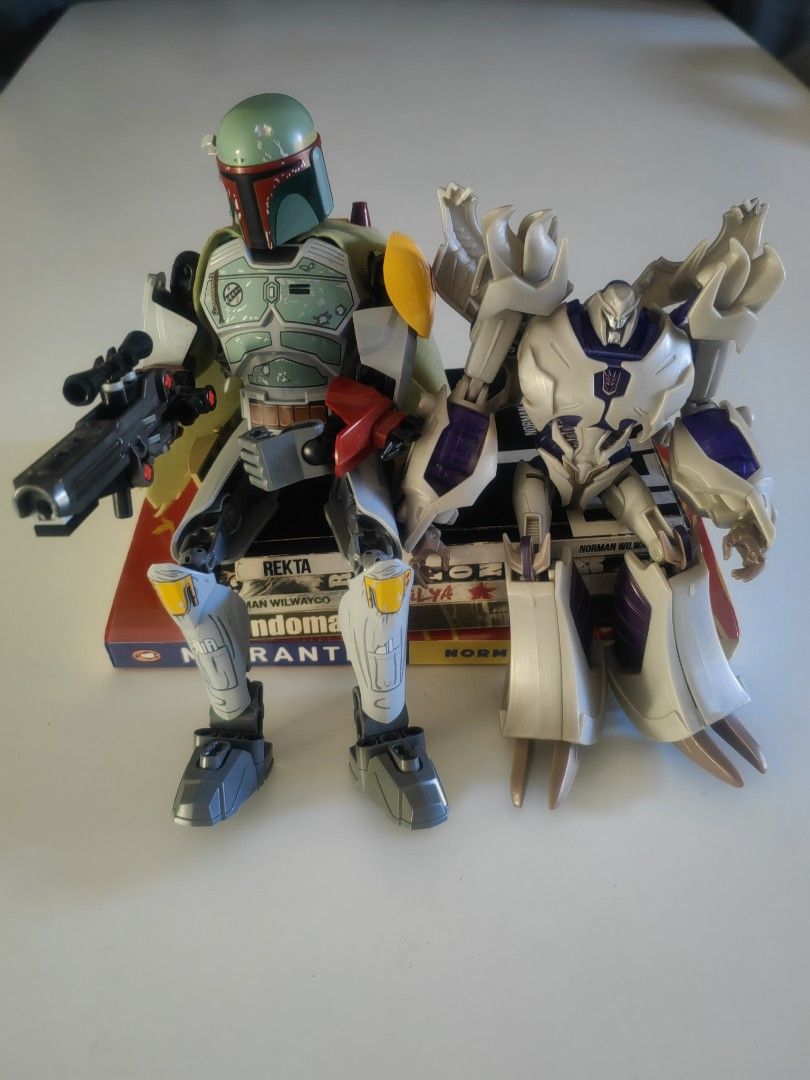 Boba Fett and Megatron Action Figures (Category: Figurines & Statues) located in Naga. Submitted by bugoy_1988 (Listing ID 1438236455, Image 1). Description: - Collectible action figures featuring Boba Fett and Megatron. - Boba Fett: - Iconic green and gray armor. - Includes a blaster. - Megatron: - Robot form. - Silver and purple color scheme. - Well-detailed and poseable figures. - Displayed on a box..