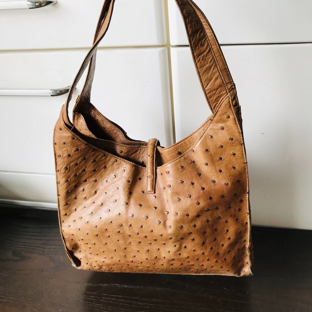 Brown Ostrich Leather Shoulder Bag (Category: Shoulder Bags) located in Baao. Submitted by all.things.japan (Listing ID 1438194209, Image 3). Description: - Brown ostrich leather shoulder bag - Single shoulder strap - Flap closure with buckle - Spacious interior - Metal feet - Distinctive textured pattern 12.5 x 3.0 x 12.0 inches.