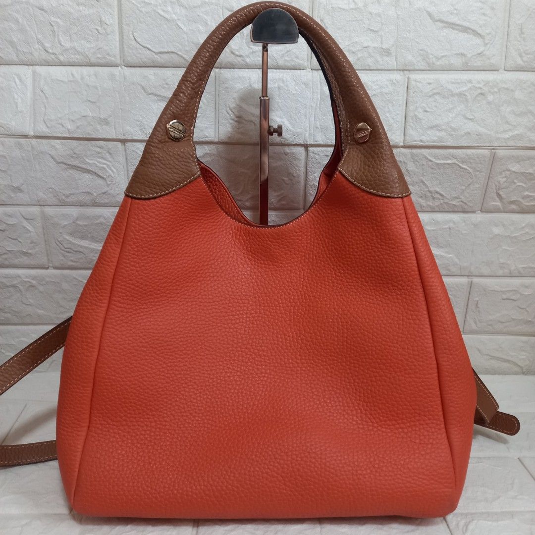 Bruno Magli Hobo 2-way Handbag (Category: Shoulder Bags) located in Las Pinas. Submitted by etoksi1234 (Listing ID 1438261478, Image 2). Description: Pre-loved Bruno Magli hobo 2-way handbag in a vibrant orange hue. Pebbled leather with gold-tone hardwares..