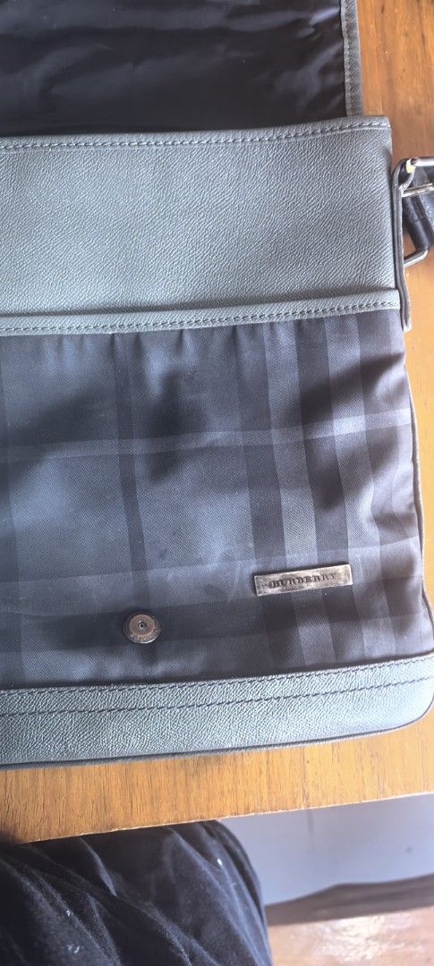 Burberry Checkered Messenger Bag (Category: Luxury Bags & Wallets) located in Cagayan de Oro. Submitted by tommygurl1218 (Listing ID 1438133487, Image 3). Description: - Burberry messenger bag - Classic checkered pattern - Secure flap closure with buckle - Adjustable shoulder strap with Burberry logo - Features a small, iconic metal Burberry logo - Constructed from a durable, potentially water-resistant material - Stylish dark color scheme With m