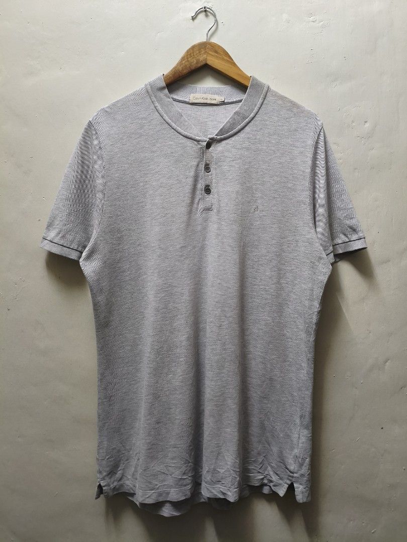 Calvin Klein Gray Henley Shirt (Category: Tshirts & Polo Shirts ) located in Mandaluyong City. Submitted by frivsthriftsph (Listing ID 1438198322, Image 1). Description: Calvin Klein Gray Henley Shirt Lightly used condition. Color rate is 10/10. Size XL on tag. Actual dimes are 22W by 31L. No other issues aside from repaired hole sa likod. See 5th pic for reference..