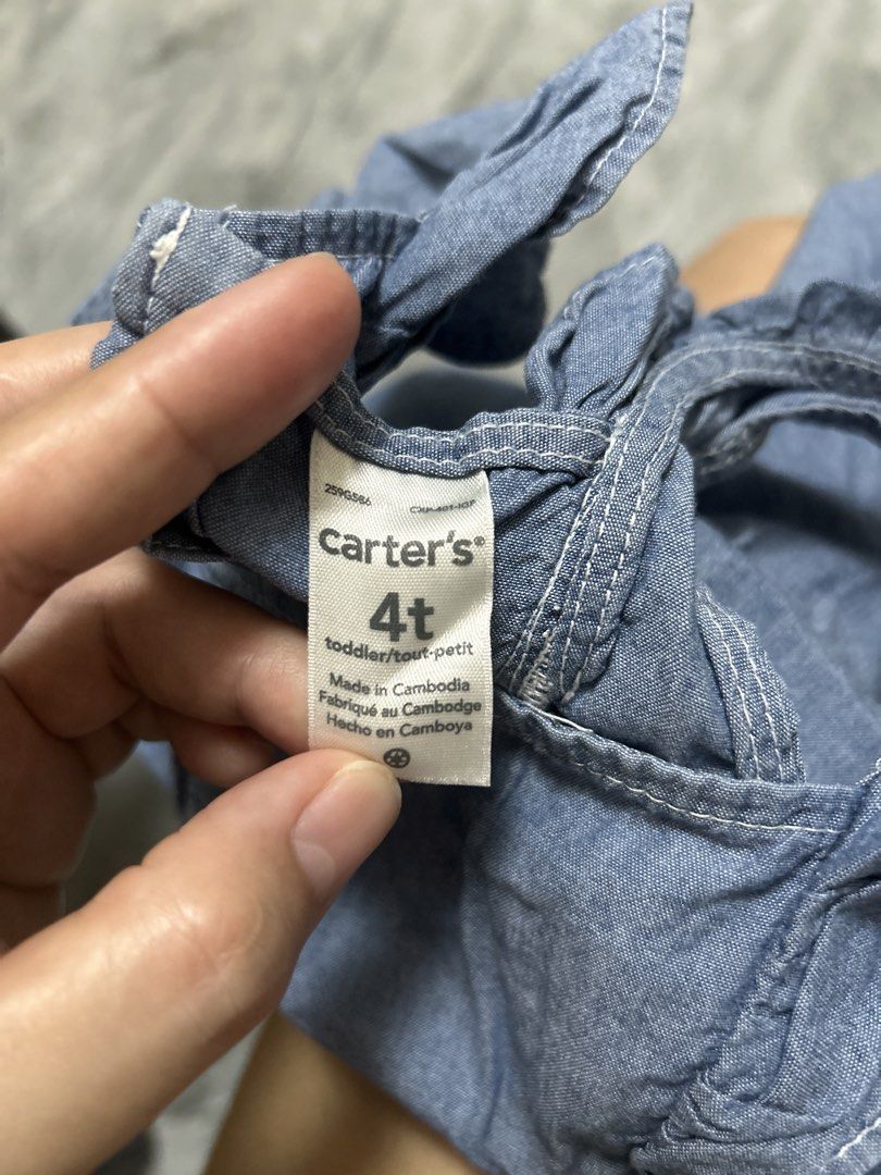 Carter's Denim Dress - 4T (Category: Babies & Kids Fashion) located in Gapan. Submitted by mysticrabbit-3195 (Listing ID 1438224200, Image 2). Description: - Carter's denim dress - Size: 4T - Design: Tie straps and button details - Made in Cambodia - Great for everyday wear and special occasions.
