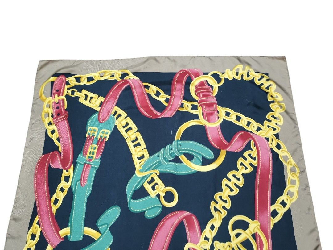 Celine Silk Scarf (Category: Scarves) located in Manila. Submitted by eagerbeaverph (Listing ID 1438217031, Image 2). Description: - Authentic Celine silk scarf - Navy blue background - Features a design of chains, belts, and ribbons in pink, green, and gold - Light brown border - Made in Italy - 100% silk Celine vintage silk scarf featuring a chain and buckle motif 33 x L32 inches Normal signs of usage No inclusions Dm .