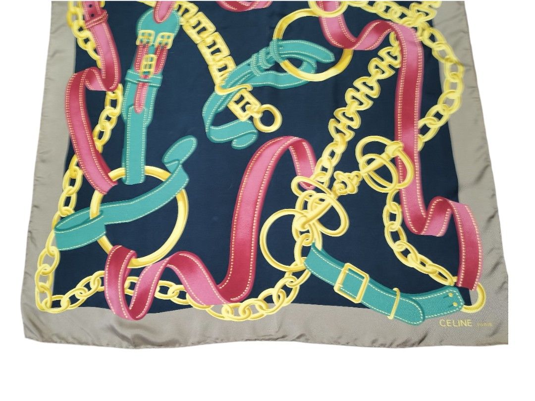 Celine Silk Scarf (Category: Scarves) located in Manila. Submitted by eagerbeaverph (Listing ID 1438217031, Image 3). Description: - Authentic Celine silk scarf - Navy blue background - Features a design of chains, belts, and ribbons in pink, green, and gold - Light brown border - Made in Italy - 100% silk Celine vintage silk scarf featuring a chain and buckle motif 33 x L32 inches Normal signs of usage No inclusions Dm .