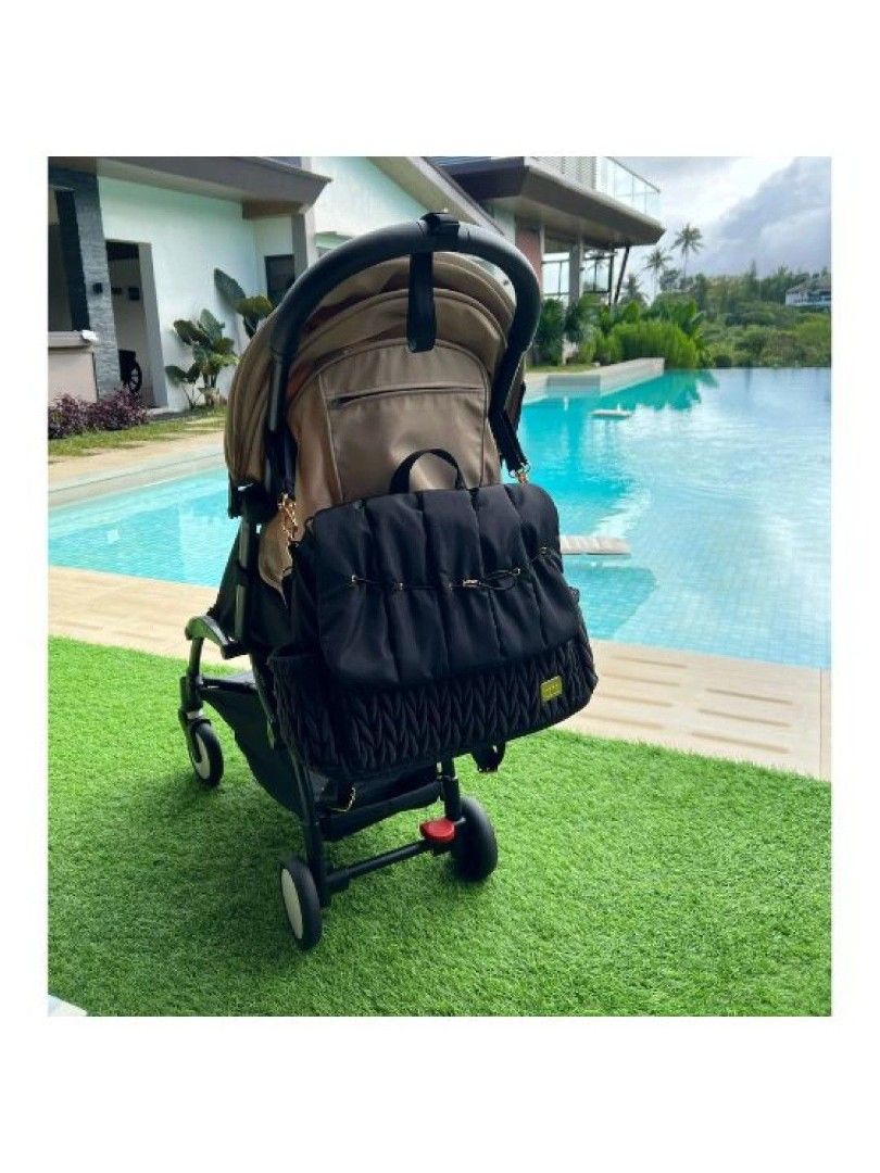 Coco Lala Black Stroller Bag diaper bag (Category: Strollers) located in Manila. Submitted by nicolealison (Listing ID 1438244962, Image 2). Description: - Black stroller bag - Multiple compartments - Quilted design - Shoulder strap included - Water-resistant material - Mesh pocket for organization - Attaches to stroller -with diaper pad last photo for issue but can be fixed. .