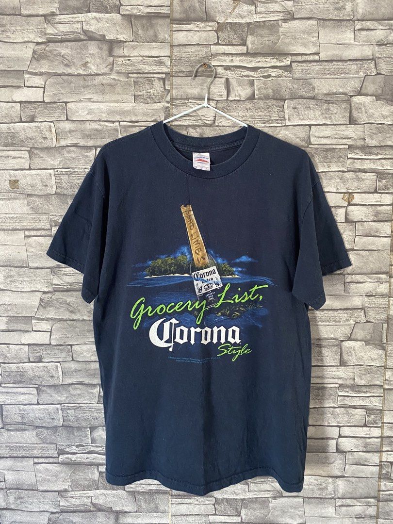 Corona Extra Grocery List T-shirt (Category: Tshirts & Polo Shirts ) located in Lingayen. Submitted by ivansellstuff (Listing ID 1438158214, Image 1). Description: - Navy blue Corona Extra t-shirt - Features a graphic of a Corona bottle on an island - Includes the text "Grocery List, Corona Style" - Standard crew neck design - Brand name visible.
