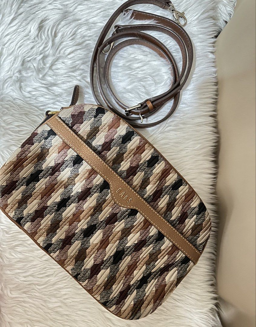 DAKS Crossbody Bag (Category: Cross-body Bags) located in Rizal. Submitted by stuffbuyph (Listing ID 1438124227, Image 3). Description: - DAKS crossbody bag - Unique patterned fabric exterior - Brown leather accents - Detachable shoulder strap - Multiple zippered compartments - Light-colored fabric lining.