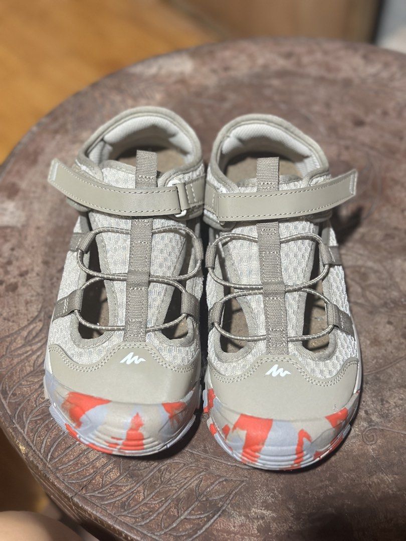 Decathlon Quechua Hiking Sandals (Category: Sneakers) located in Manila. Submitted by declutbykai (Listing ID 1438261100, Image 2). Description: - Quechua outdoor sandals - Used once - Designed for outdoor activities - Breathable mesh upper - Adjustable straps for a secure fit - Patterned soles for grip - Neutral color scheme - Red accents on toe and sole.