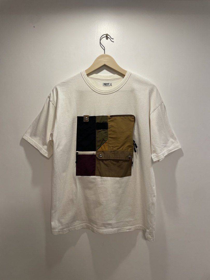 Egrn Tokyo Japan Patchwork Pocket T-shirt (Category: Tshirts & Polo Shirts ) located in Bacolod City. Submitted by moboandmoga (Listing ID 1438191761, Image 1). Description: - Egrn Tokyo Japan T-shirt - Unique patchwork pocket design - Size: M (Size 2) - Color: Off-white - Main Body: 100% Cotton - Patchwork: 60% Cotton, 40% Nylon - Pocket features multiple compartments and zippers (Sizing info) Width: 21.5 inches Length: 26.5" Excellent Condition