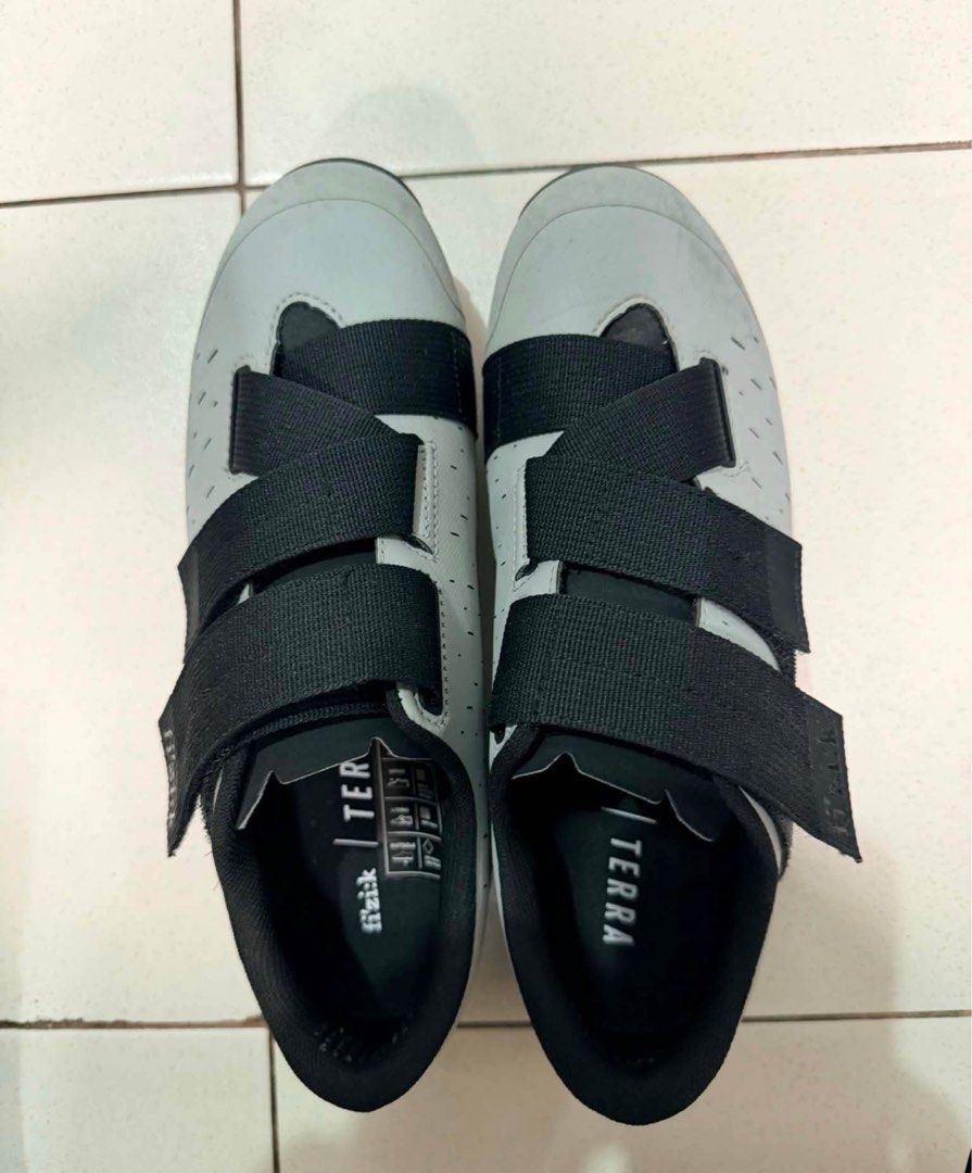 Fizik Terra Cycling Shoes (Category: Other Sports Equipment and Supplies) located in Binan City. Submitted by trendytots (Listing ID 1438165097, Image 1). Description: - Fizik Terra cycling shoes - Size 41 - Color: Grey and black - Features velcro straps - Perforated design for breathability - Cleats on soles for pedal attachment.