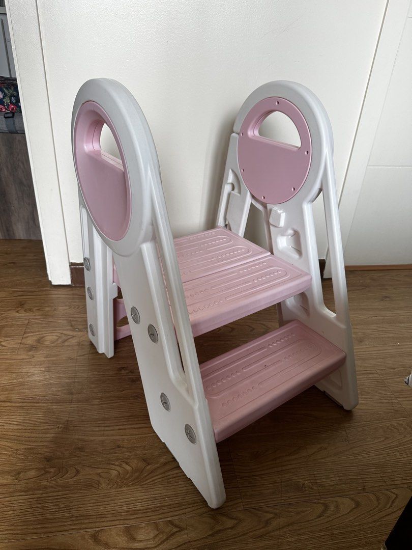 Foldable Step Stool with Handle (Category: Chairs) located in Manila. Submitted by mike.ed (Listing ID 1438123515, Image 2). Description: - Foldable step stool for kids - Three steps for easy access - Convenient carrying handle - Folds flat for compact storage - Durable white and pink plastic construction - Ideal for reaching high places or helping little ones.