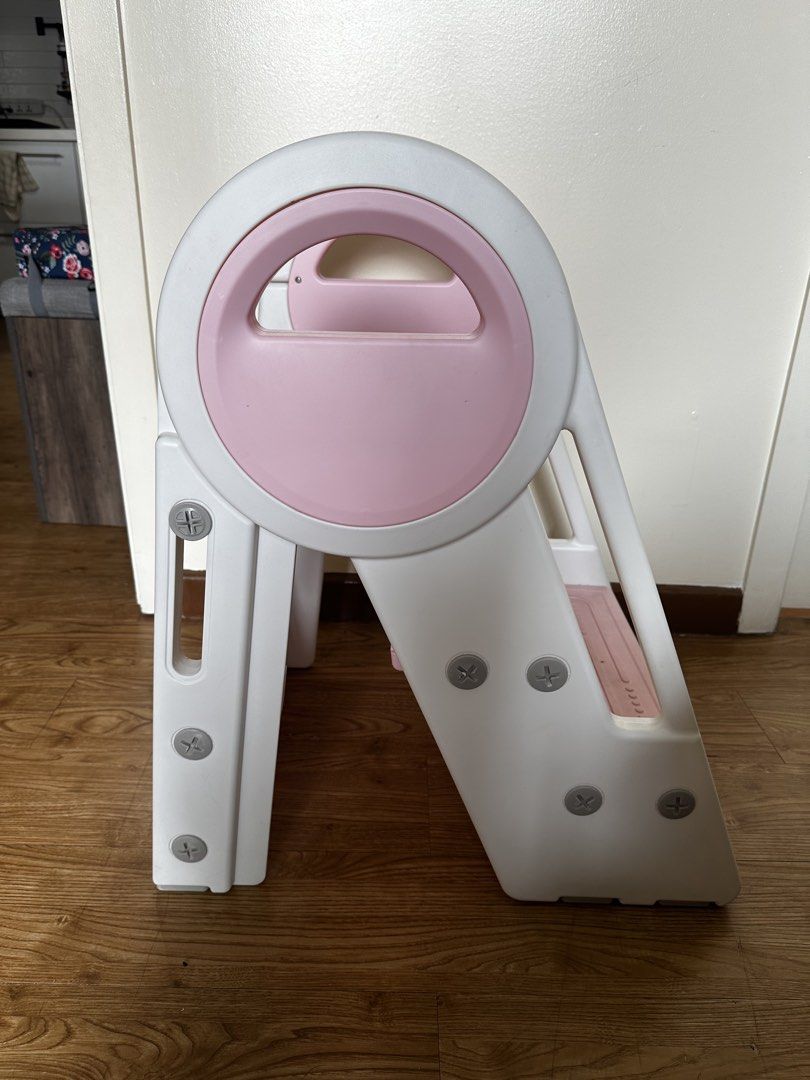 Foldable Step Stool with Handle (Category: Chairs) located in Manila. Submitted by mike.ed (Listing ID 1438123515, Image 3). Description: - Foldable step stool for kids - Three steps for easy access - Convenient carrying handle - Folds flat for compact storage - Durable white and pink plastic construction - Ideal for reaching high places or helping little ones.
