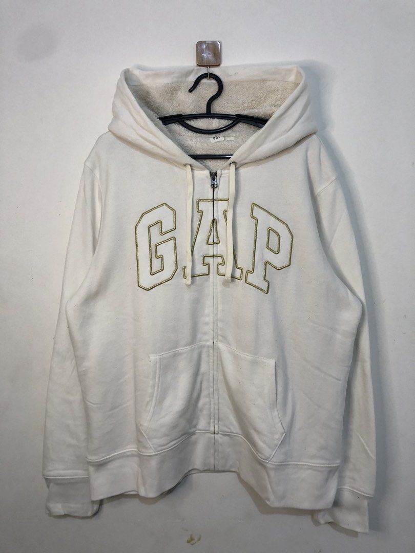 GAP Zip-Up Hoodie (Category: Hoodies) located in Manila. Submitted by kosathrifted. (Listing ID 1438280913, Image 1). Description: - White GAP zip-up hoodie - Fleece-lined hood - GAP logo on front - Zipper closure - Two front pockets - Standard fit - Tag visible.