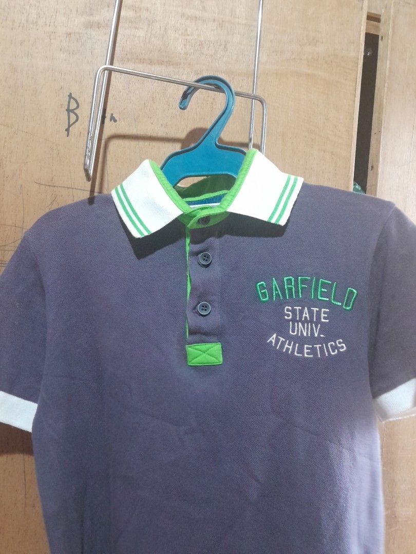 Garfield poli shirt (Category: Babies & Kids Fashion) located in Manila. Submitted by maceler (Listing ID 1438121572, Image 3). Description: - Garfield State University Athletics polo shirt - Dark gray color - collar green and white accents - Garfield logo patch on sleeve cuff - Large size on tag - Size 7-9 depends on the size of kids.