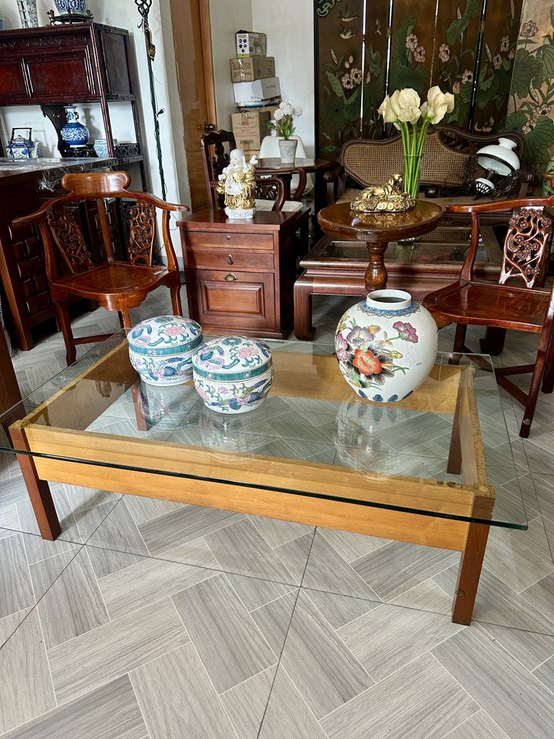 Glass Top Coffee Table (Category: Tables & Sets) located in Quezon City. Submitted by cddelarrazabal (Listing ID 1438191805, Image 2). Description: #greatasianfinds A striking rectangular wooden coffee table with glass top, showcasing a clean, architectural silhouette. The exposed wooden supports beneath the glass highlight its minimalist, structural design—a look often associated with mid-century modern and brutalist influences. Size: 48” L x 29