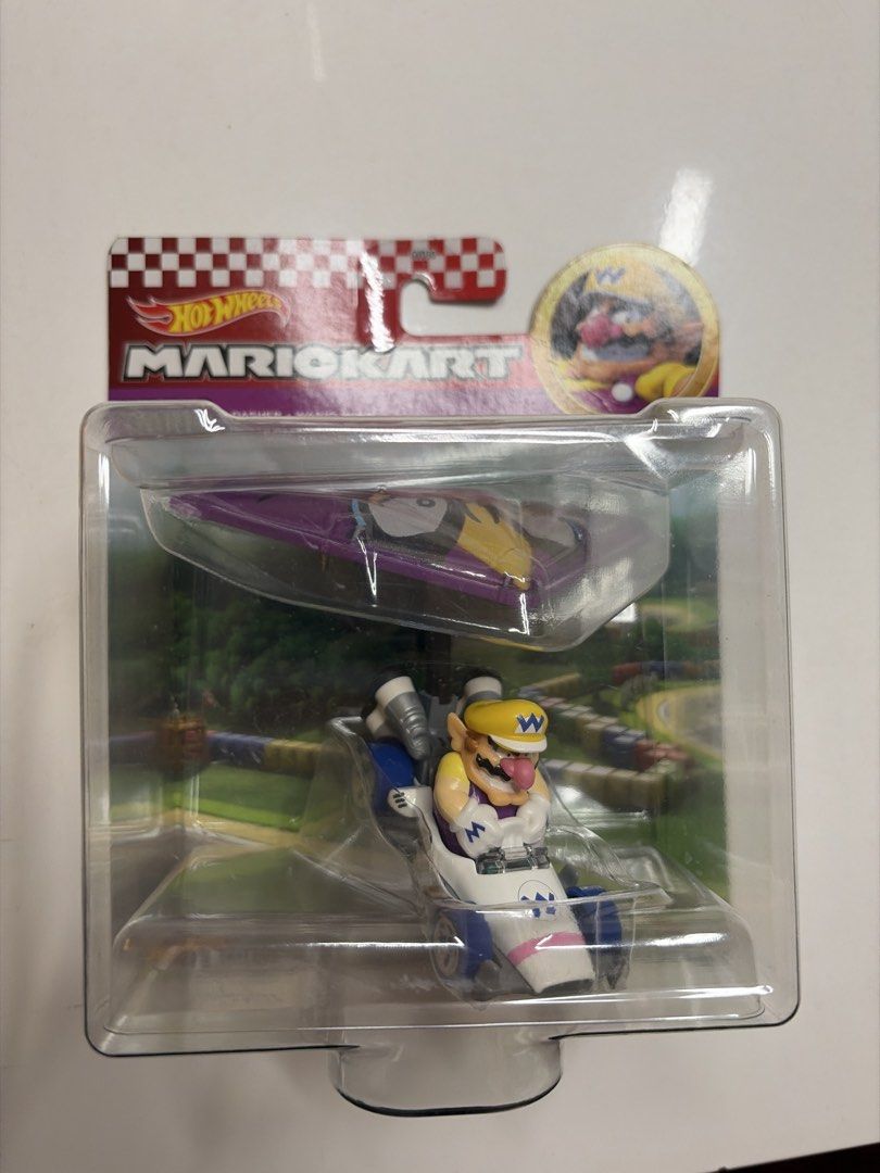Hot Wheels Mario Kart Wario (Category: Vehicle & Diecast Models) located in Quezon City. Submitted by so_san (Listing ID 1438256473, Image 1). Description: - Hot Wheels Mario Kart Wario toy car. - Brand new, in original packaging. - Features the iconic Mario Kart logo. - Packaging showcases other Mario Kart characters. - Perfect for collectors and fans! - rfs: decluttering :) brand new and unopened .