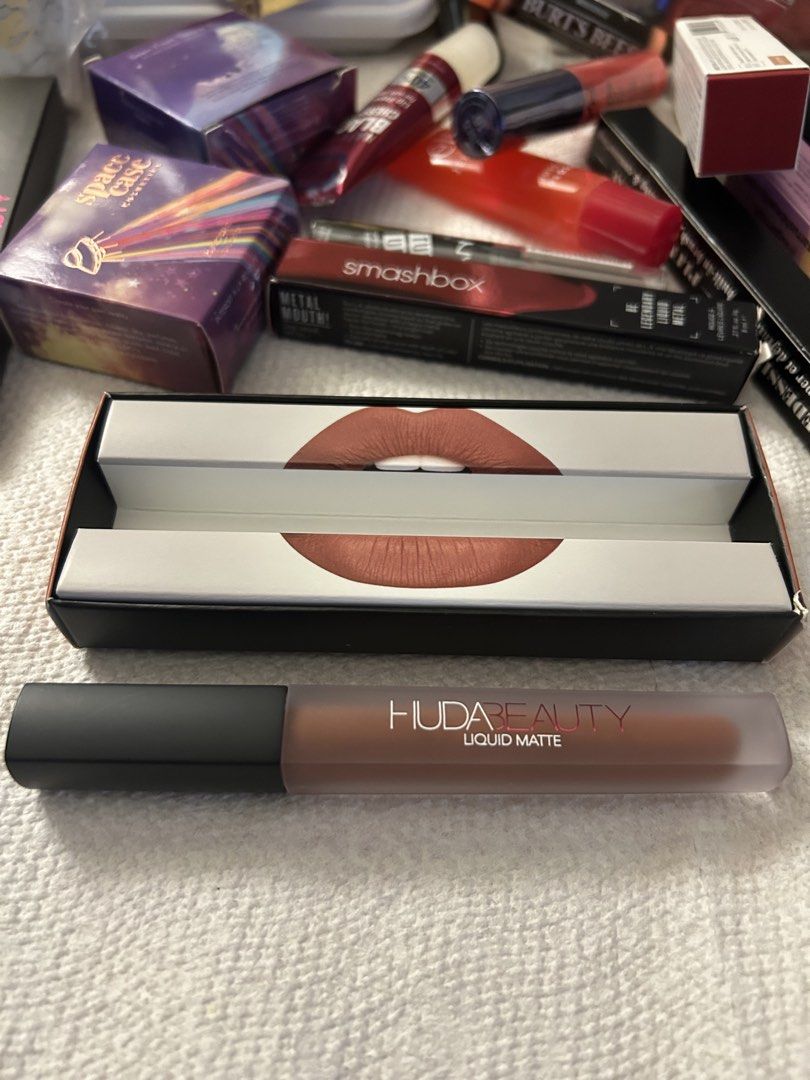 Huda Beauty Liquid Matte Lipstick - Trendsetter (Category: Makeup) located in Angeles City. Submitted by mycl0set (Listing ID 1438150822, Image 1). Description: - Huda Beauty Liquid Matte Lipstick - Shade: Trendsetter (warm nude-brown) - Brand new, in original packaging - Features lip design and Huda Beauty logo on box - Frosted lipstick tube with black cap.