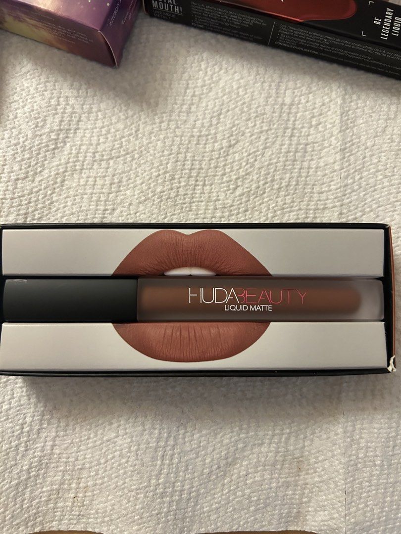 Huda Beauty Liquid Matte Lipstick - Trendsetter (Category: Makeup) located in Angeles City. Submitted by mycl0set (Listing ID 1438150822, Image 3). Description: - Huda Beauty Liquid Matte Lipstick - Shade: Trendsetter (warm nude-brown) - Brand new, in original packaging - Features lip design and Huda Beauty logo on box - Frosted lipstick tube with black cap.