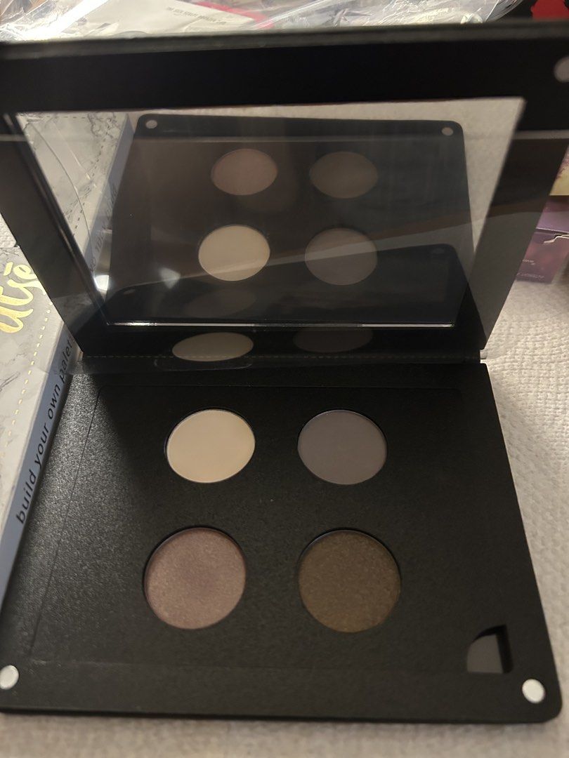 ittse Magnetic Palette with Eyeshadows (Category: Makeup) located in Angeles City. Submitted by mycl0set (Listing ID 1438137192, Image 2). Description: - Rose gold ittse magnetic palette - Features four eyeshadow shades: light beige, grey, shimmery taupe, and dark brown - Includes a built-in mirror - ittse logo embossed on the front.
