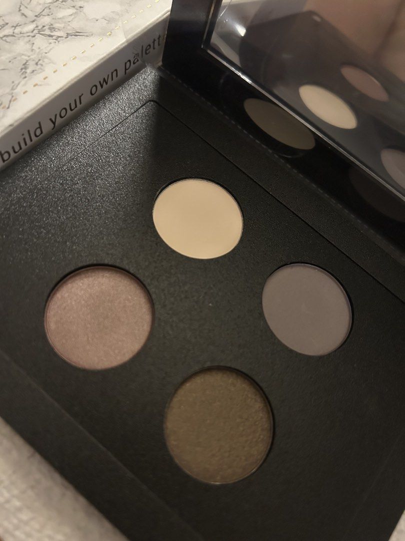 ittse Magnetic Palette with Eyeshadows (Category: Makeup) located in Angeles City. Submitted by mycl0set (Listing ID 1438137192, Image 3). Description: - Rose gold ittse magnetic palette - Features four eyeshadow shades: light beige, grey, shimmery taupe, and dark brown - Includes a built-in mirror - ittse logo embossed on the front.