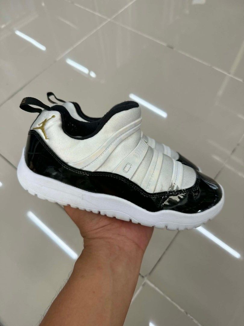 Jordan 11 CMFT Low (TD) - Black/White (Category: Sneakers) located in Bacolod City. Submitted by aprild. (Listing ID 1438183504, Image 3). Description: - Jordan 11 CMFT Low (TD) sneakers - Size: US 2Y, UK 1.5, EUR 32.5, CM 21 - Features a black patent leather toe - White upper - Gold Jumpman logo - Pull tab on the heel - Designed for toddlers.