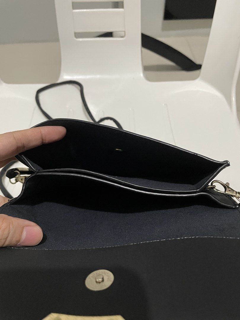 Jovanni Black Crossbody Bag (Category: Cross-body Bags) located in Taytay. Submitted by annequeen88 (Listing ID 1438224603, Image 3). Description: - Jovanni black crossbody bag - Flap closure with gold-colored accent - Long, thin strap for shoulder or crossbody wear - Multiple interior compartments - Made of textured material - Jovanni logo visible.