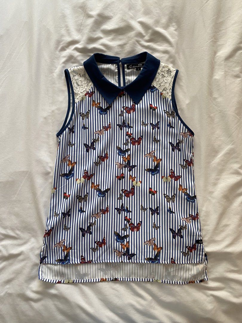 Kamiseta Butterfly Print Top - Size S (Category: Blouses) located in Quezon City. Submitted by ashleyken (Listing ID 1438173049, Image 1). Description: - Kamiseta top - Size: Small - Design: Butterfly print on striped background - Features: Navy blue collar, lace shoulder detailing - Style: Sleeveless - Material: Lightweight.