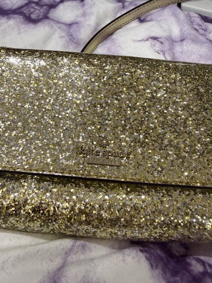 Kate Spade Glitter Crossbody Bag (Category: Luxury Bags & Wallets) located in Taguig. Submitted by maicacu90 (Listing ID 1438224818, Image 1). Description: - Kate Spade crossbody bag - Dazzling glitter exterior - Flap closure - Gold-toned chain strap - Light-colored fabric lining - Includes tag - Stylish accessory.