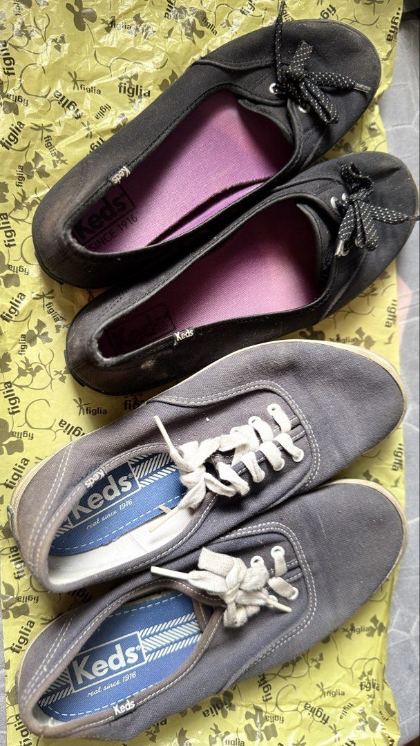 Keds Black and Gray Sneakers (Category: Sneakers) located in Quezon City. Submitted by charleydesagun (Listing ID 1438140814, Image 1). Description: - Pair of Keds sneakers - Black pair: bow detail - Gray pair: white laces, blue insoles with Keds logo - Both pairs: visible Keds logo.