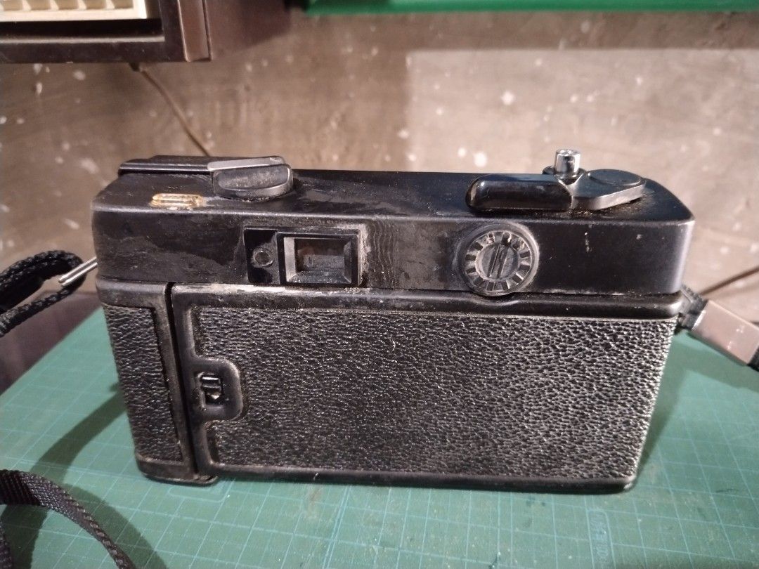 Konica C35 EF Film Camera (Category: Cameras) located in Manila. Submitted by megazordbuilderhunter (Listing ID 1438168222, Image 2). Description: - Konica C35 EF film camera - 38mm f/2.8 Konica Hexanon lens - Built-in flash - Includes camera strap - ASA setting - Accessible film compartment - Black camera body.