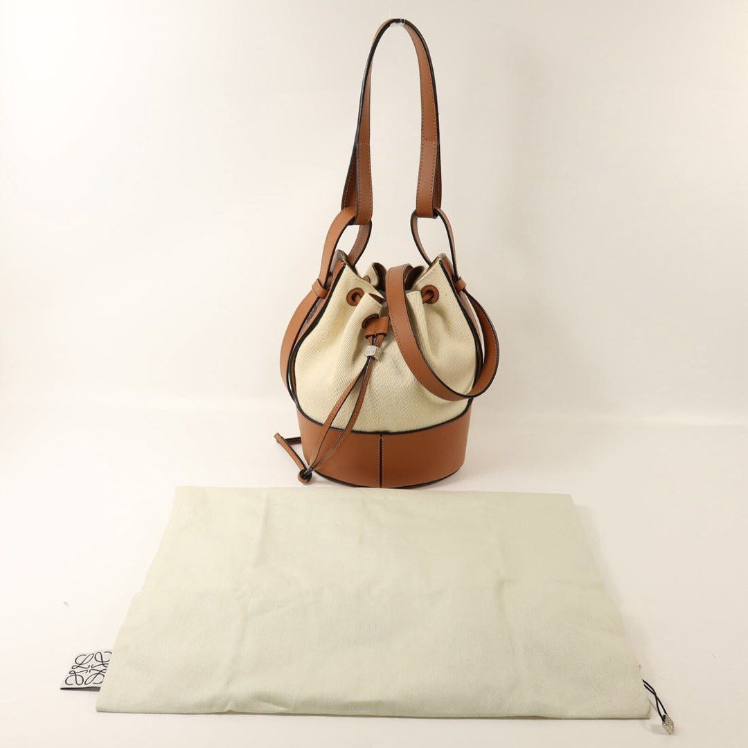 Loewe Bucket Bag with Drawstring Closure (Category: Luxury Bags & Wallets) located in Taguig. Submitted by sourcedbym (Listing ID 1438113122, Image 1). Description: - Loewe bucket bag - Drawstring closure - Tan leather base and trim - Cream canvas body - Includes dust bag - Tan leather handles - Classic and elegant design.