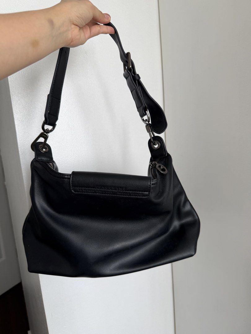 Longchamp Black Hobo Bag (Category: Luxury Bags & Wallets) located in Marikina City. Submitted by ukaiiukai (Listing ID 1438160386, Image 3). Description: - Longchamp black leather shoulder bag - Flap closure with snap button - Adjustable shoulder strap - Interior zippered pocket - Includes original tags.