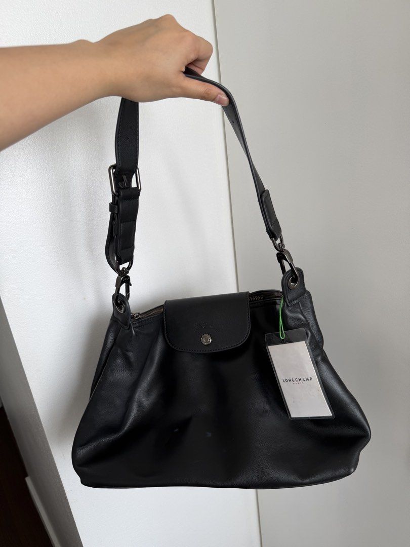 Longchamp Black Hobo Bag (Category: Luxury Bags & Wallets) located in Marikina City. Submitted by ukaiiukai (Listing ID 1438160386, Image 1). Description: - Longchamp black leather shoulder bag - Flap closure with snap button - Adjustable shoulder strap - Interior zippered pocket - Includes original tags.