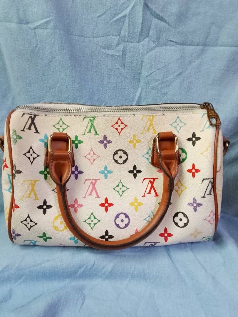 Louis Vuitton Multicolor Speedy Bag (Category: Luxury Bags & Wallets) located in San Juan City. Submitted by prestinebag (Listing ID 1438192919, Image 2). Description: - Multicolor Speedy bag - Brown leather handles and trim - Front pocket with clasp closure - White base with colorful LV logos - Silver-toned zipper - Smaller size, ideal for everyday use.
