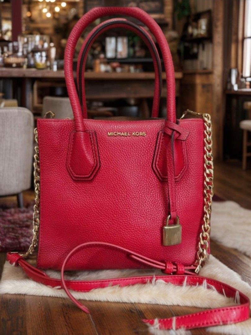Mk Mercier (Category: Luxury Bags & Wallets) located in Manila. Submitted by bellissima05 (Listing ID 1437562529, Image 1). Description: Featuring a chic and fabulous style, this MICHAEL Michael Kors tote has a high appeal. Crafted from red pebbled leather, the bag features dual top handles, a removable shoulder strap, and a padlock. It opens to a spacious leather and nylon interior, which is divided by a zipper compartment. Length : 21 cm Width 