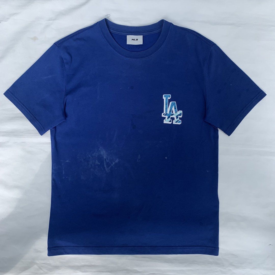 MLB Los Angeles Dodgers T-shirt (Category: Tshirts & Polo Shirts ) located in Zamboanga. Submitted by dherick38 (Listing ID 1438182832, Image 2). Description: - Blue Los Angeles Dodgers T-shirt - Features the iconic LA logo - Classic crew neck design - Short sleeves - Minor stains on the front - Authentic MLB merchandise.