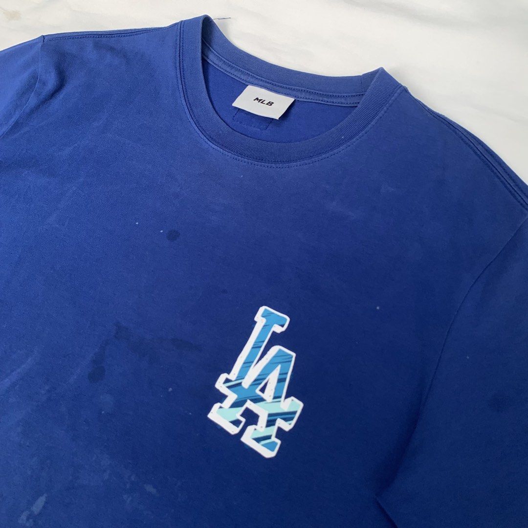 MLB Los Angeles Dodgers T-shirt (Category: Tshirts & Polo Shirts ) located in Zamboanga. Submitted by dherick38 (Listing ID 1438182832, Image 3). Description: - Blue Los Angeles Dodgers T-shirt - Features the iconic LA logo - Classic crew neck design - Short sleeves - Minor stains on the front - Authentic MLB merchandise.