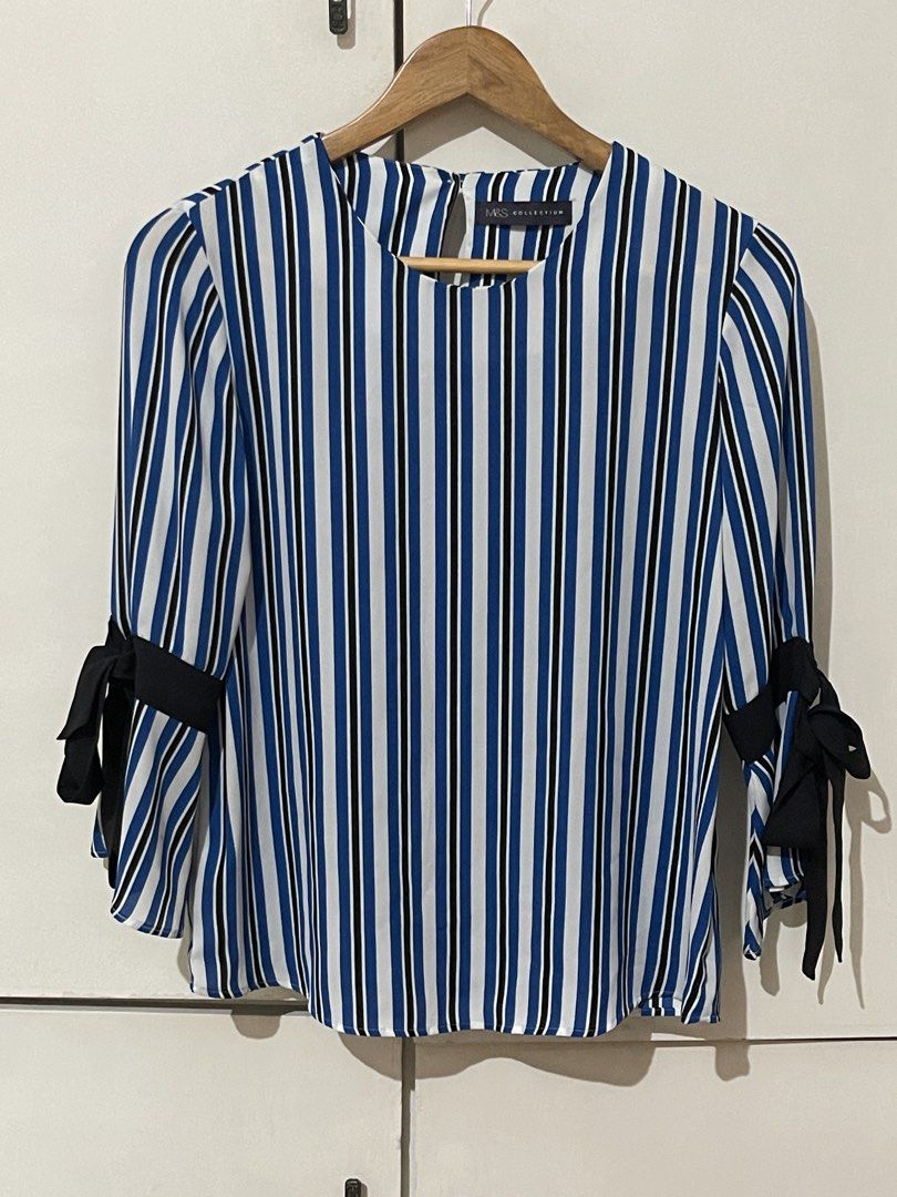 M&S Collection Striped Blouse with Bow Sleeves (Category: Blouses) located in Santa Cruz. Submitted by lilpurpleseven (Listing ID 1438130866, Image 1). Description: - M&S Collection blouse - Vertical stripes in blue, black, and white - Round neckline - 3/4 sleeves with black bow details - Keyhole opening at the back - Button closure - Brand new with tag.