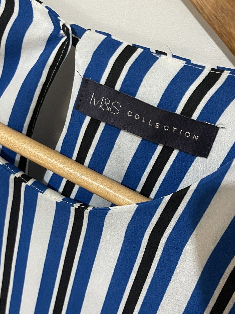 M&S Collection Striped Blouse with Bow Sleeves (Category: Blouses) located in Santa Cruz. Submitted by lilpurpleseven (Listing ID 1438130866, Image 3). Description: - M&S Collection blouse - Vertical stripes in blue, black, and white - Round neckline - 3/4 sleeves with black bow details - Keyhole opening at the back - Button closure - Brand new with tag.