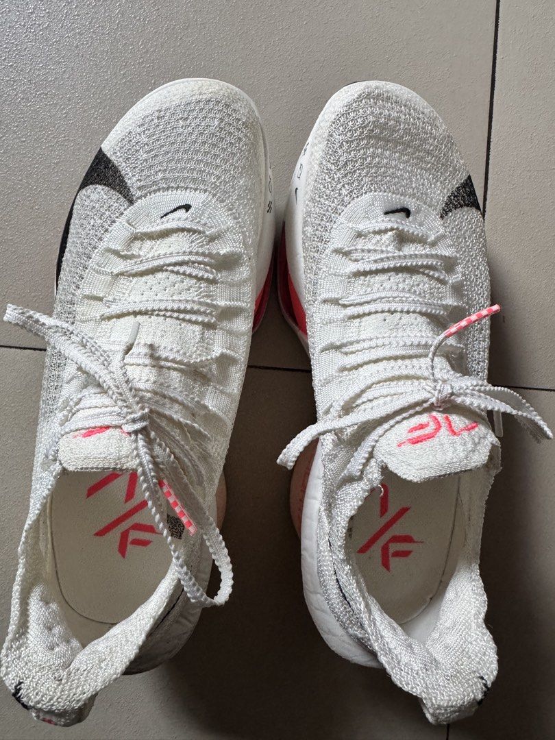 Nike Air Zoom Alphafly 3 White/ Guava (Category: Sneakers) located in Taguig. Submitted by pamraq (Listing ID 1438193451, Image 2). Description: - Nike Air Zoom Alphafly Next% 2 - Color: White with black Nike swoosh and pink accents - Size: US 7, EUR 38, UK 4.5 - Condition: slightly used. 20km usage - Technology: Flyplate and Zoom Air - Details: White laces with pink tips, pink logo on insole - with box.