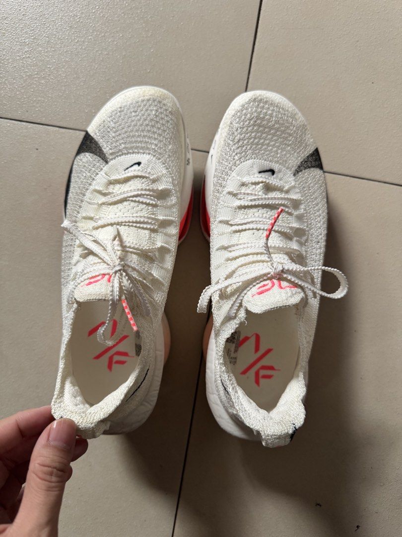 Nike Air Zoom Alphafly 3 White/ Guava (Category: Sneakers) located in Taguig. Submitted by pamraq (Listing ID 1438193451, Image 3). Description: - Nike Air Zoom Alphafly Next% 2 - Color: White with black Nike swoosh and pink accents - Size: US 7, EUR 38, UK 4.5 - Condition: slightly used. 20km usage - Technology: Flyplate and Zoom Air - Details: White laces with pink tips, pink logo on insole - with box.