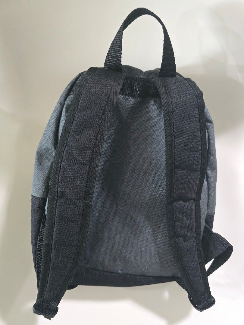 Nike Mini Backpack - Black (Category: Babies & Kids Fashion) located in Singapore. Submitted by november_1231 (Listing ID 1438174708, Image 3). Description: - Black Nike backpack - Small front zip pocket - Adjustable straps - Perfect for carrying essentials - Suitable for primary school books - Features the Nike swoosh.